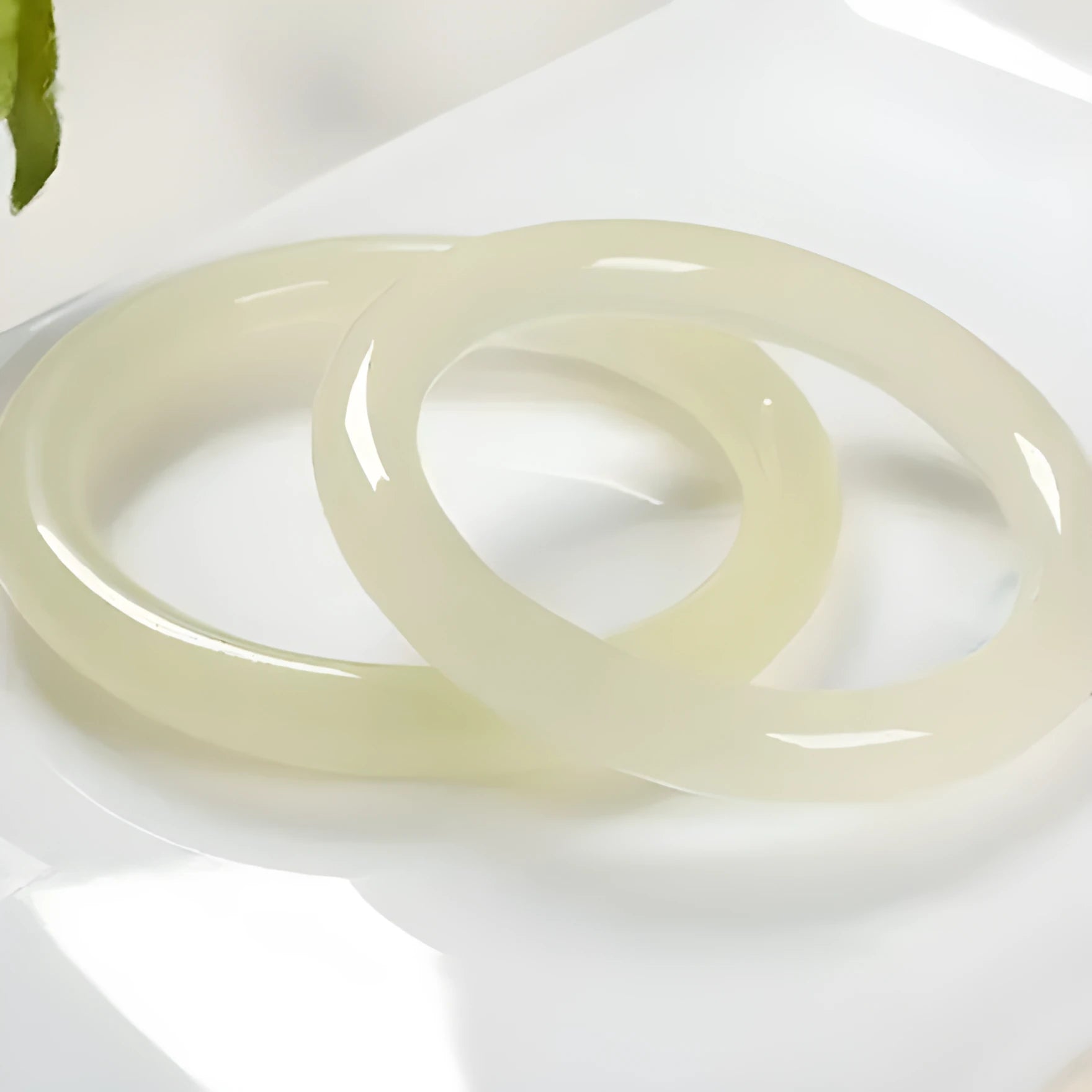 Ice silk jade round bar bracelet shown on a wrist, highlighting its smooth cylindrical shape and natural stone material.