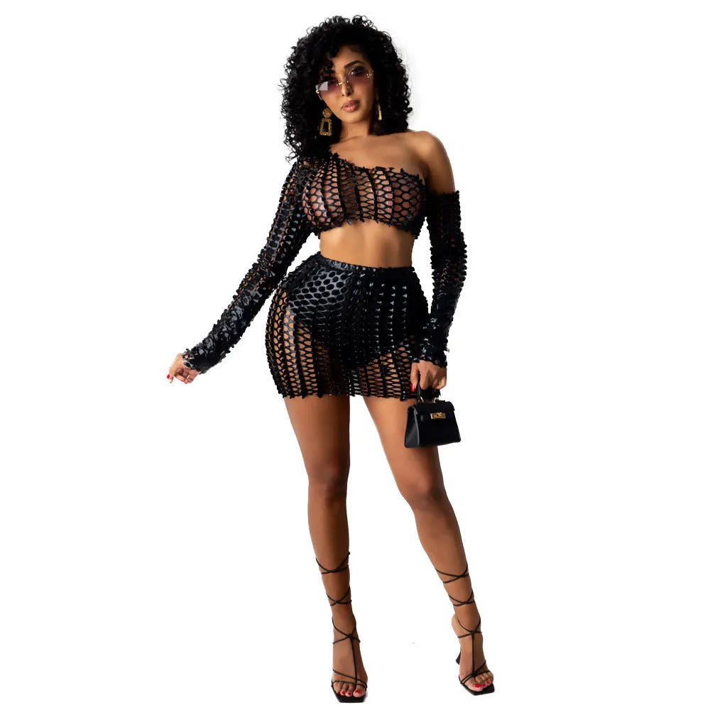 Women's black hollow-out two-piece set with sleeveless top and short skirt on a model.