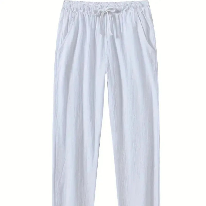 Man wearing loose-fitting cotton beach trousers in a solid colour, showcasing casual summer style.