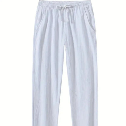 Man wearing loose-fitting cotton beach trousers in a solid colour, showcasing casual summer style.