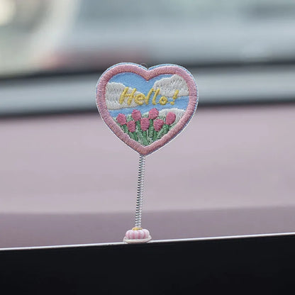 Set of six small yellow PVC duckling car decorations and one cartoon sign on a car dashboard.
