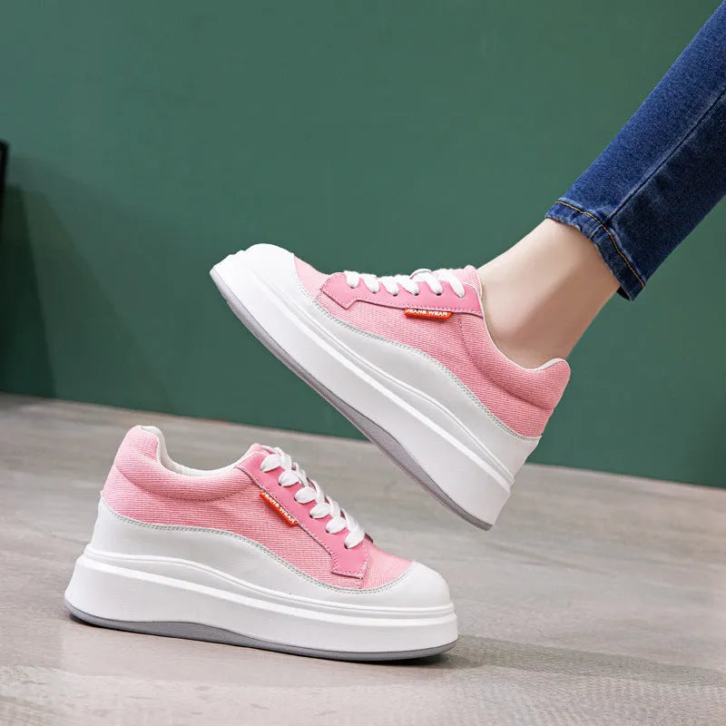 Women's pink leather board shoes with thick height-increasing sole on beige background