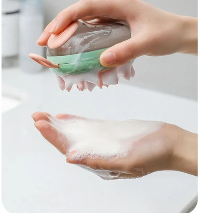 Blue and green pet bath brush with silicone bristles and a shampoo dispenser bottle in hand.