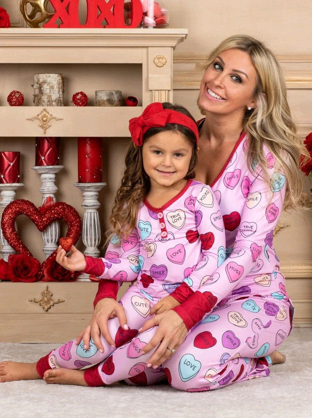 Adorable heart-printed family pajamas with long-sleeve tops and full-length bottoms in a range of sizes for children and adults.