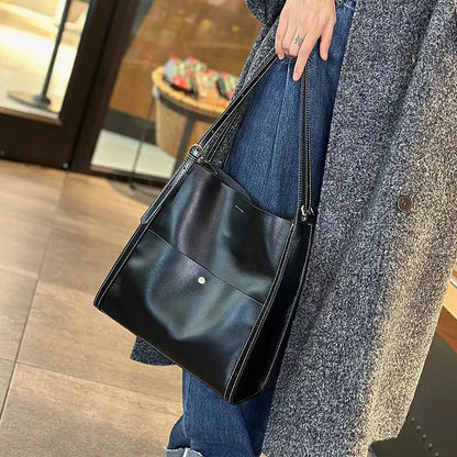 Genuine leather women's tote bag in a square shape with multiple internal pockets, shown in sunset yellow.