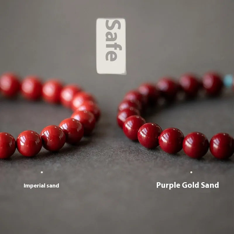 Purple Gold Sand cinnabar bracelet with geometric ellipse beads and a metal clasp on a wrist.