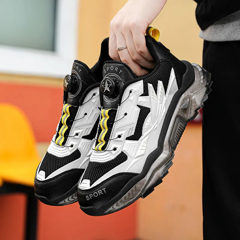 Men's black casual shoes with a rotating button fastener and mesh upper on a low platform sole