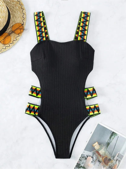 Women's one-piece swimming suit bikini in solid black or orange, made from polyester fabric, showing front view