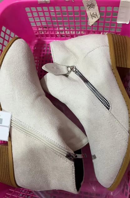 Women's suede ankle boots with a side zip and chunky heel in beige, shown from the side.