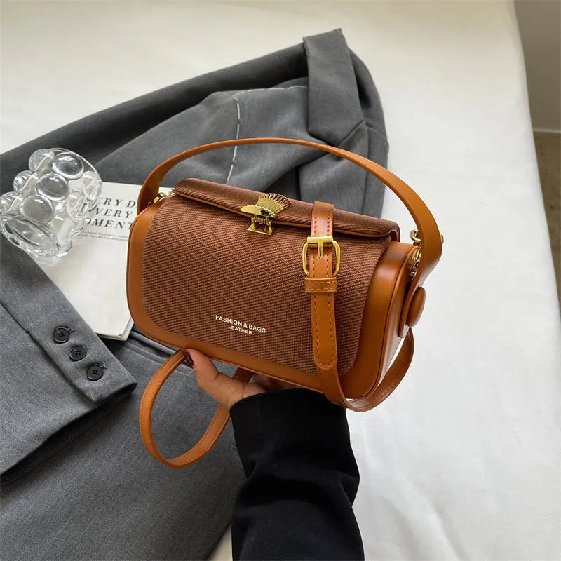 Women's PU leather messenger bag in a horizontal square shape with a lock and adjustable shoulder strap.