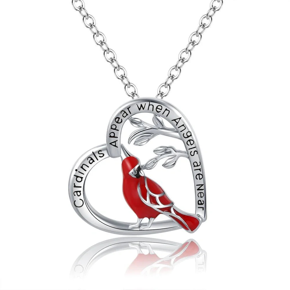 Elegant heart-shaped cardinal pendant necklace with a silver finish, perfect for gifting.