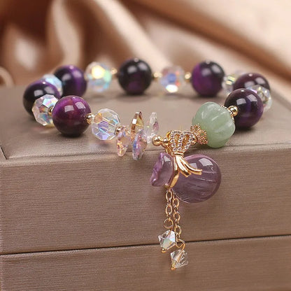 Women's crystal bracelet with purple tigereye money bag pendant and rhinestone decorations