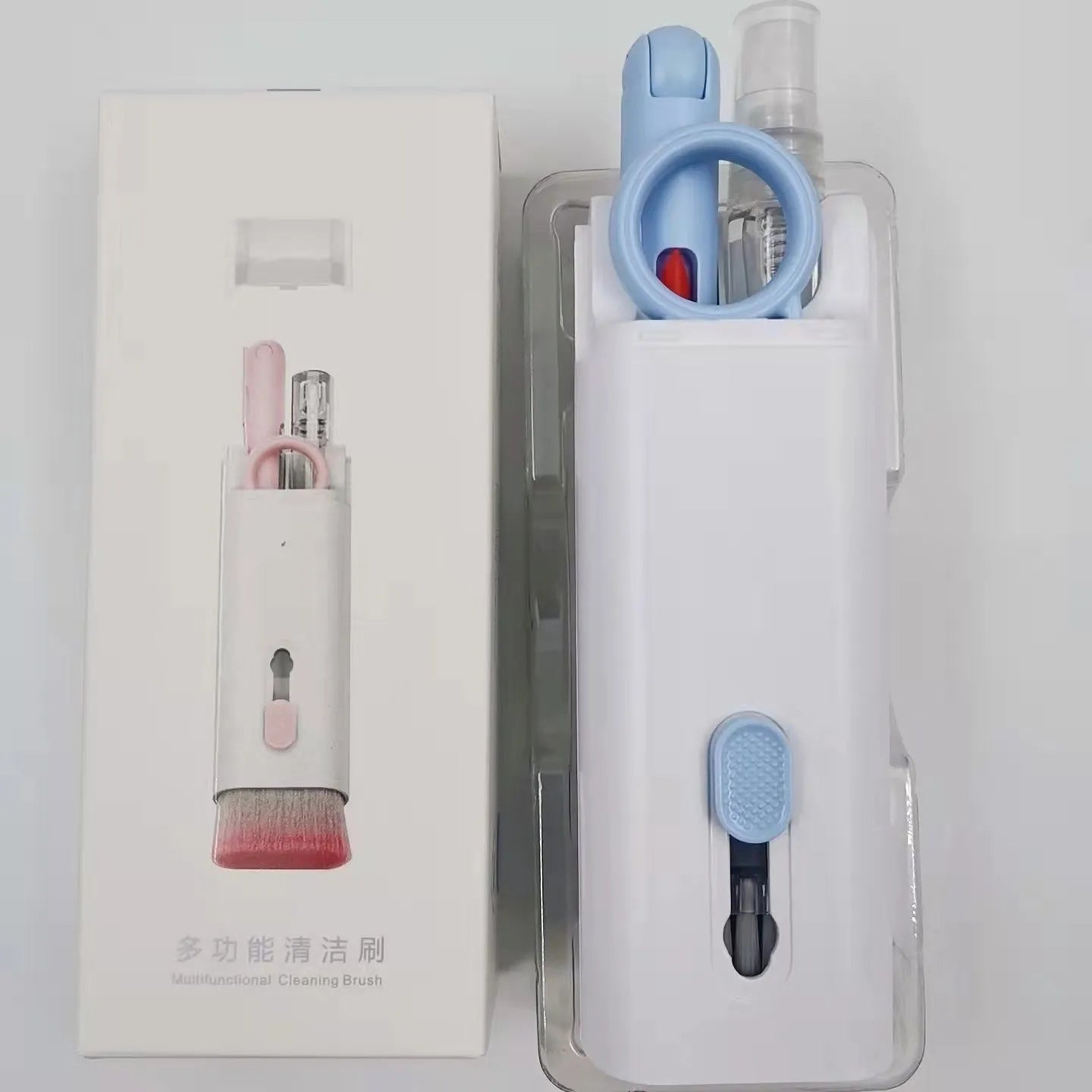 White electronics cleaning kit with a cleaning pen, spray bottle, brush, and keycap puller on a table