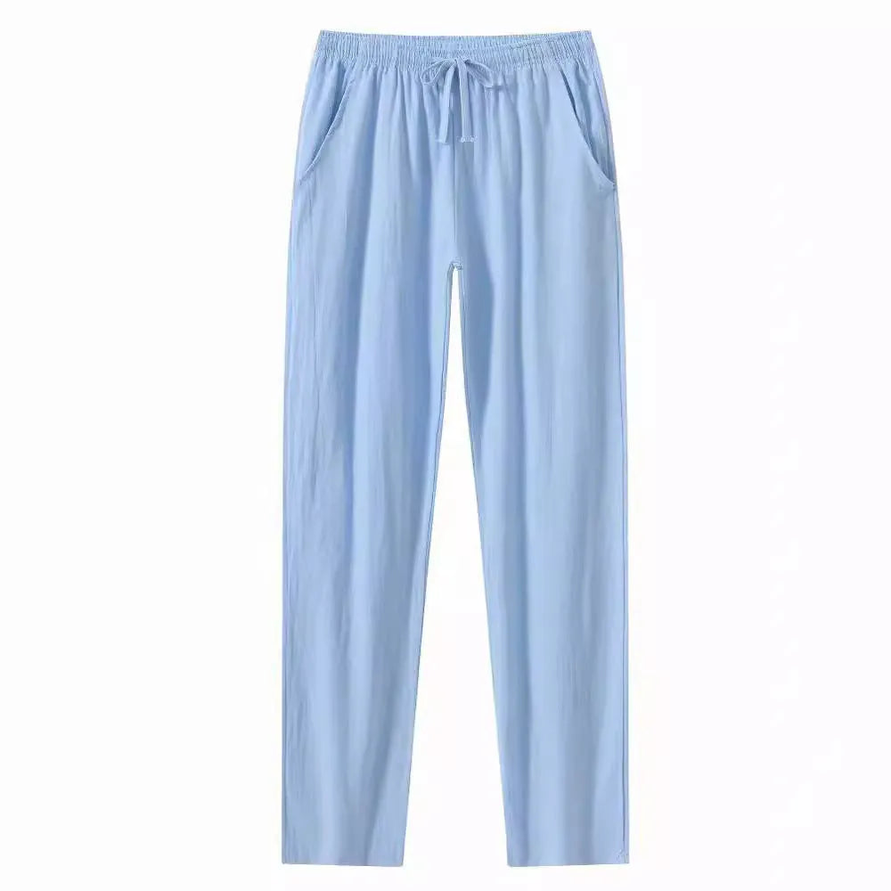 Man wearing loose-fitting cotton beach trousers in a solid colour, showcasing casual summer style.