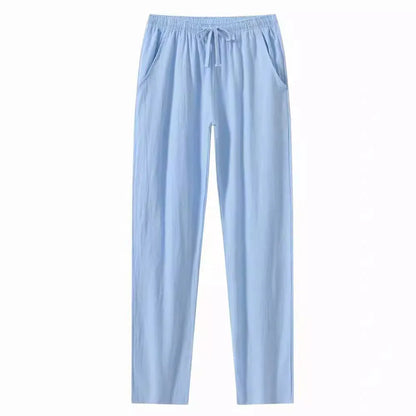 Man wearing loose-fitting cotton beach trousers in a solid colour, showcasing casual summer style.