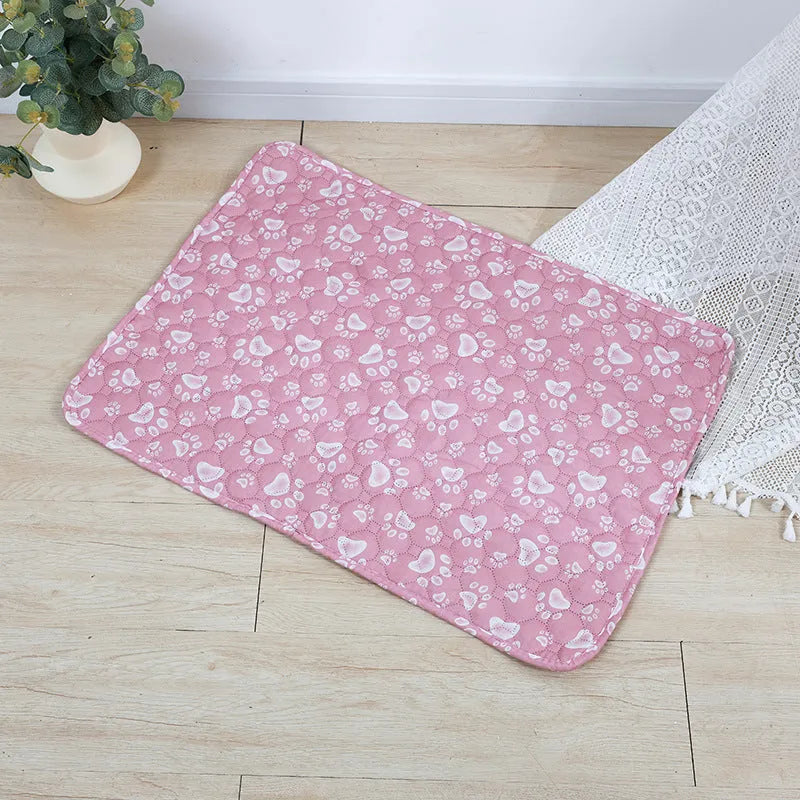 Reusable washable pet urine pad showing colourful animal pattern and waterproof backing.