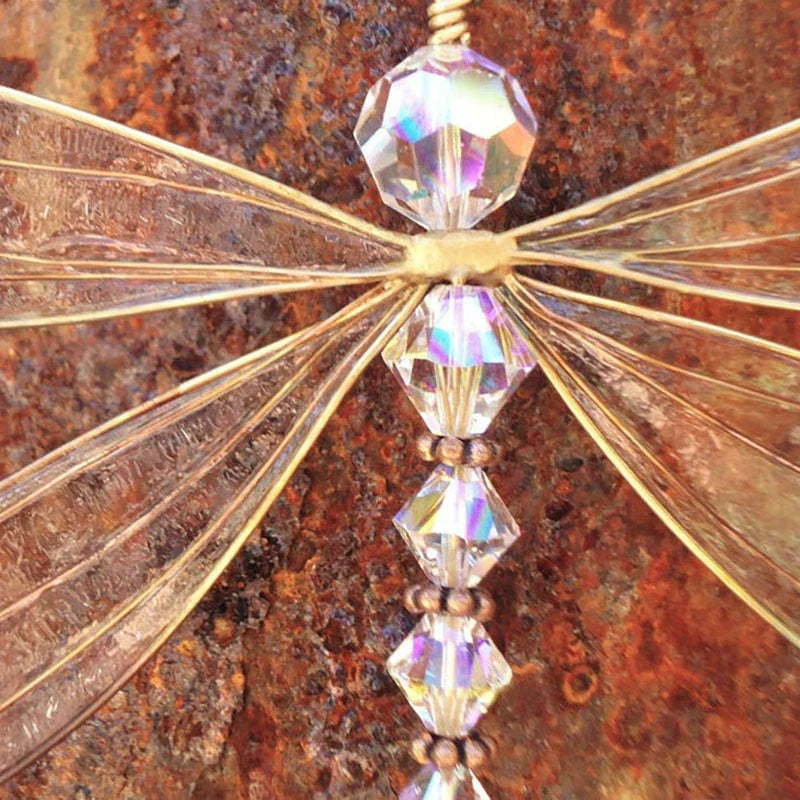 Elegant dragonfly-shaped crystal suncatcher with vibrant rainbow reflections