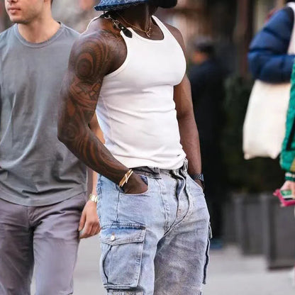 A sleeveless tight-fit vest in a solid colour, shown in either white or black.