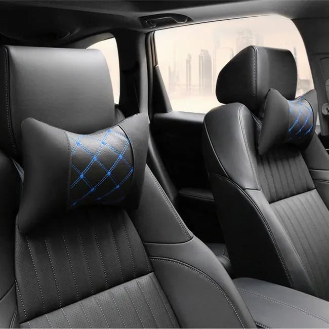Black leather quilted car headrest with diamond pattern and red stitching lines on cervical support pillow
