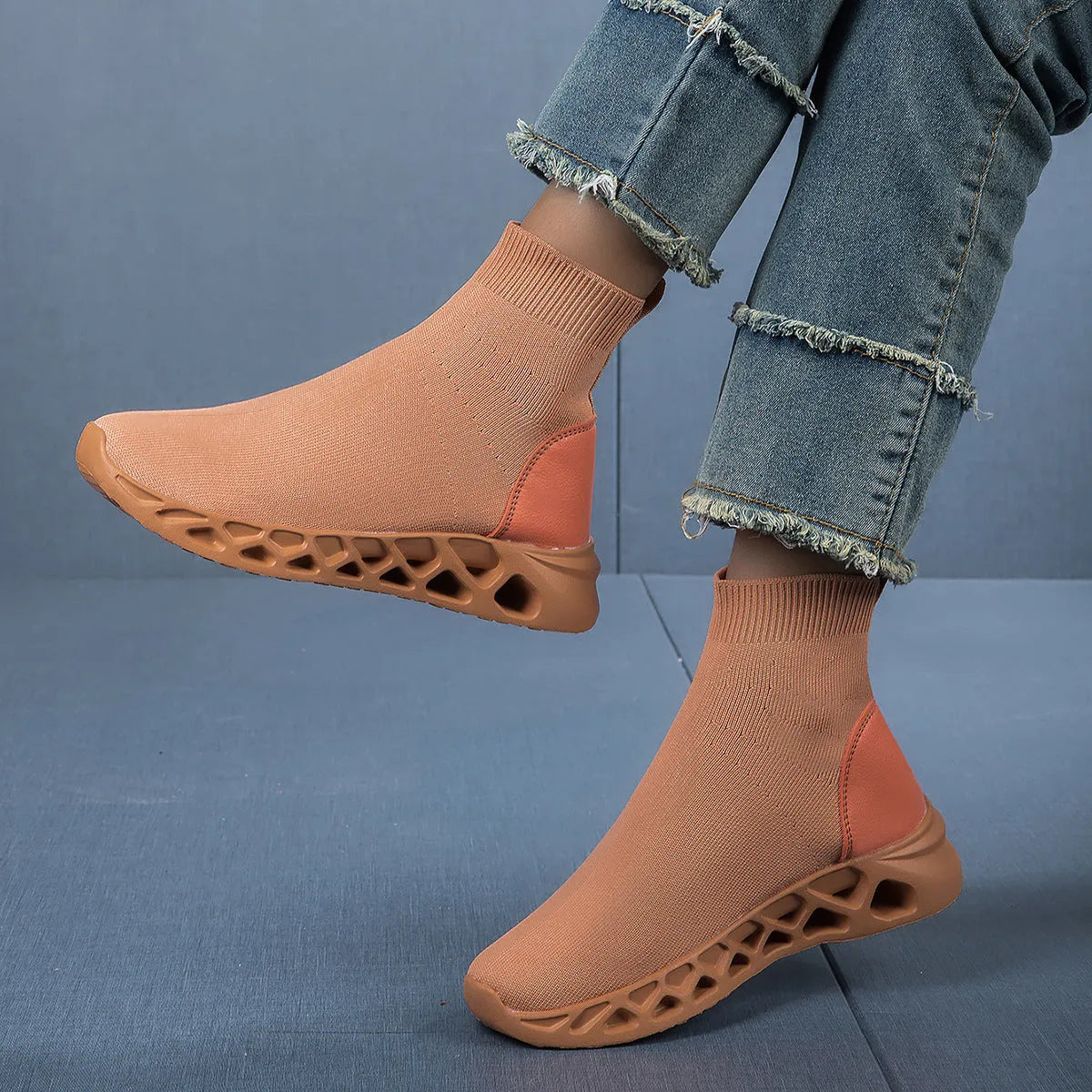 Women's casual mesh slip-on shoes in terracotta colour with flat sole and sewing line detail.