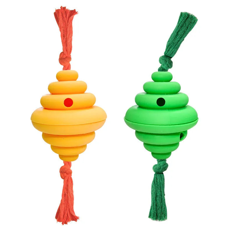 Green and yellow dog ball with attached knotted rope chew and feeder toy on grass.