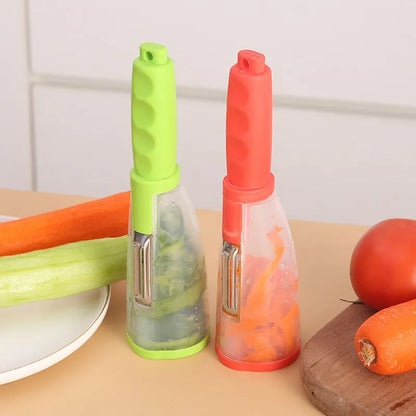 Green vegetable peeler with a transparent storage box attached, showing a stainless steel blade.