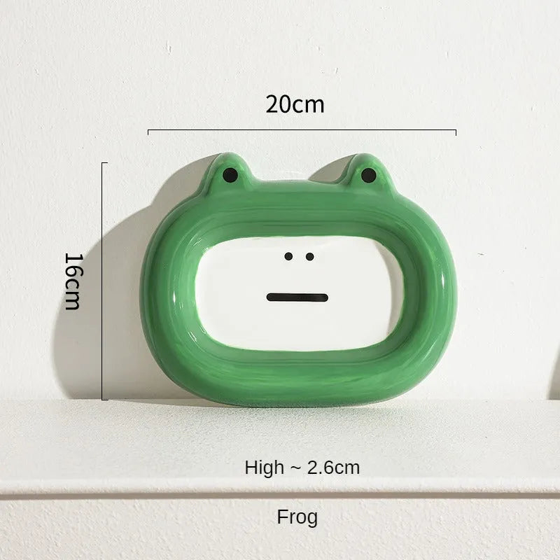 Four ceramic animal-themed pet bowls with frog, panda, pig, and fortune cat designs and silicone non-slip bases