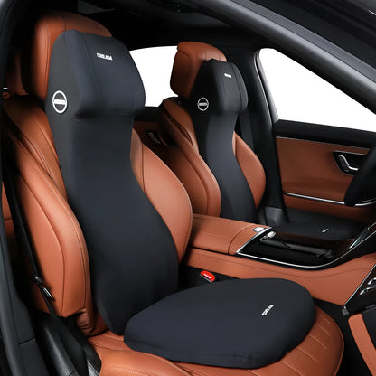 Black memory foam automotive waist cushion and matching headrest pillow set on a car seat.