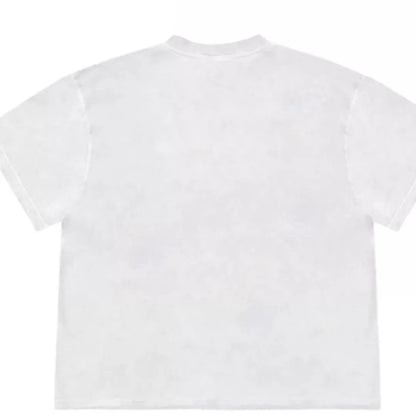 A loose-fit blueberry patchwork short-sleeve T-shirt on a hanger, showing plant and flower designs.