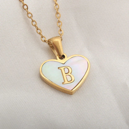 Gold-plated heart necklace with white shell pendant showing letter personalisation option