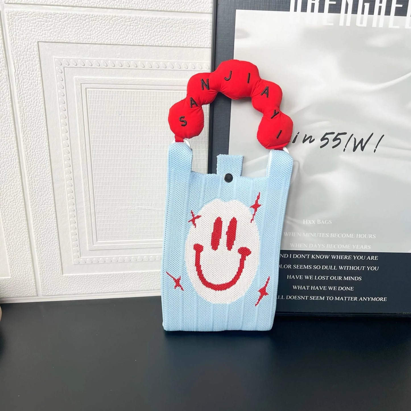 Cartoon knitted messenger bag with polyester construction and internal mobile phone storage