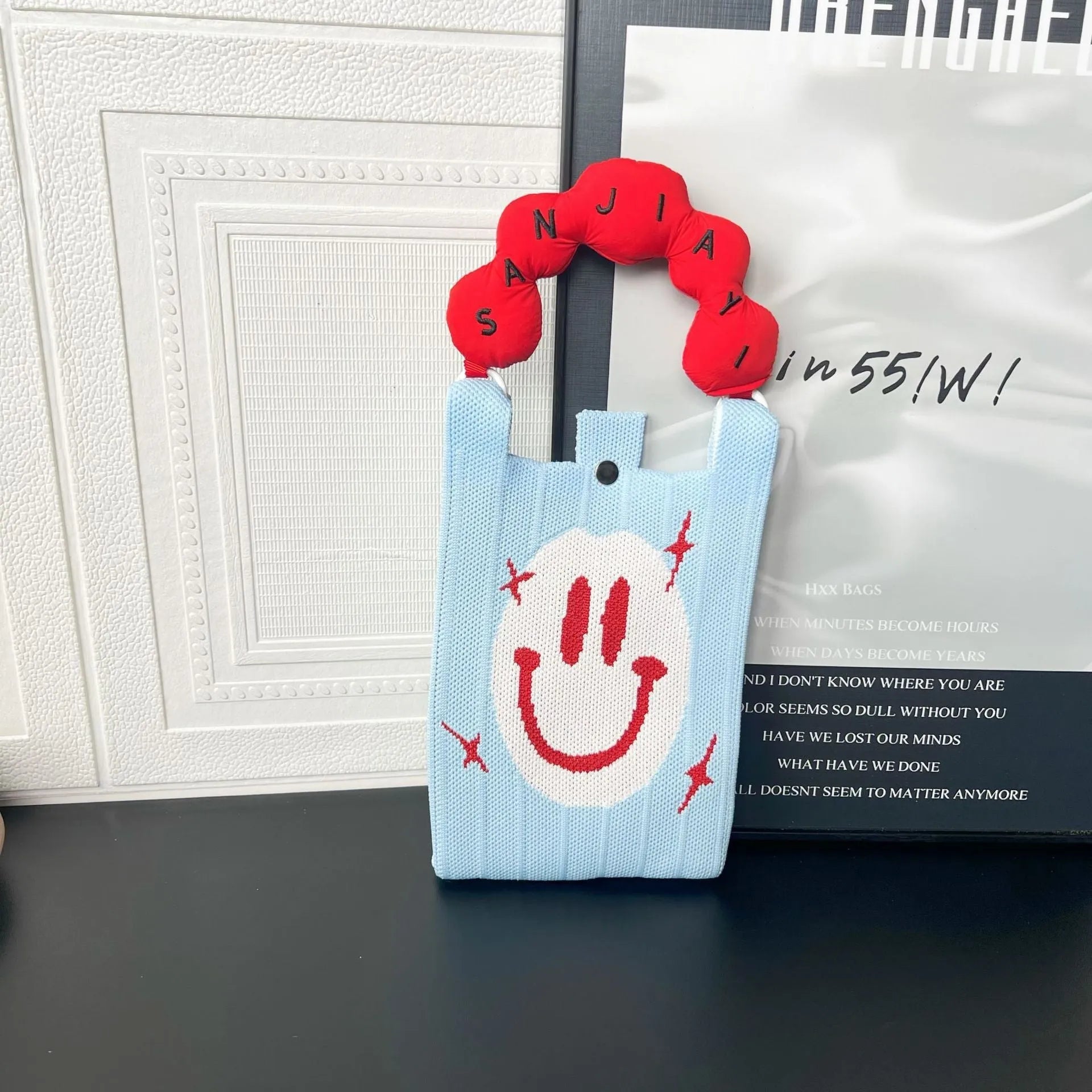 Cartoon knitted messenger bag with polyester construction and internal mobile phone storage