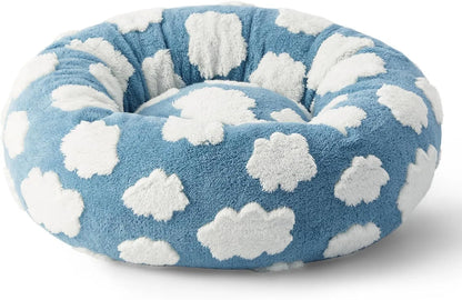 Round blue and white plaid dog bed with plastic sides on wooden floor