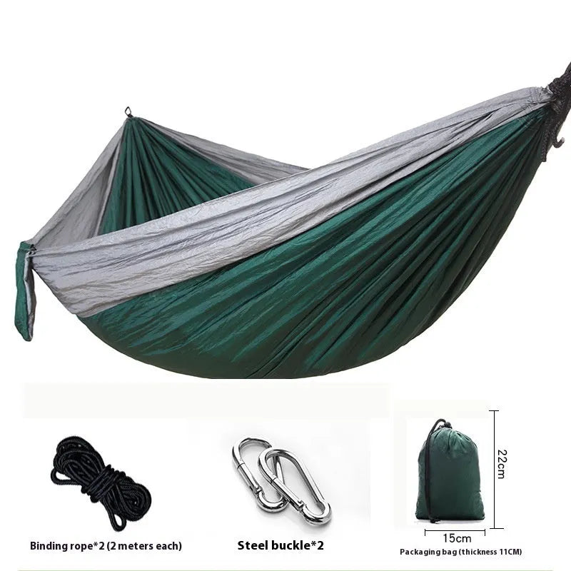 Parachute cloth double camping hammock in chosen colour, with black buckles and round ropes on a tree.