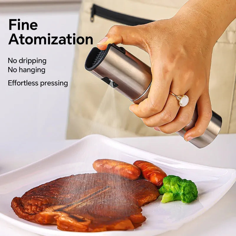 Glass oil spray bottle with stainless steel press cap showing 100ml capacity