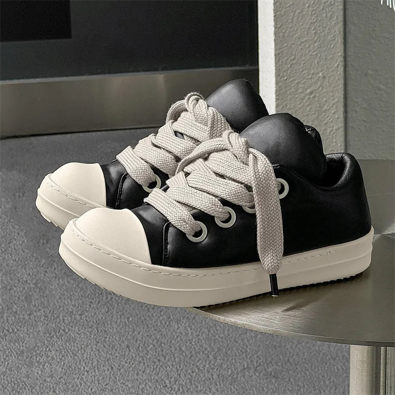 Black men's slip-on casual shoes with leather upper, rubber sole, and raised platform design