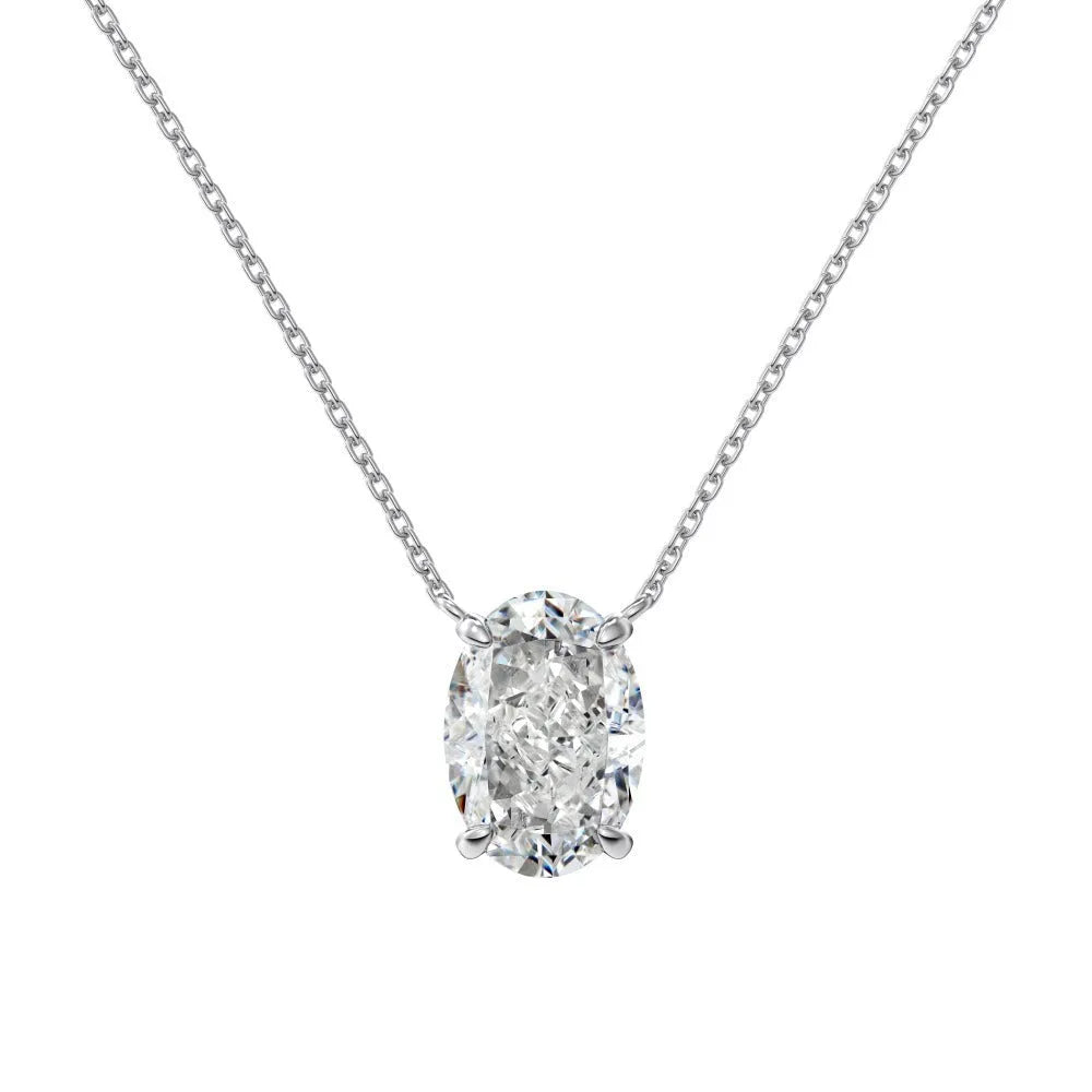 Close-up of a geometric oval ice flower pendant on a sterling silver necklace, showing gold or platinum finish.