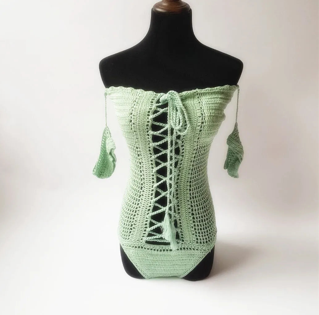 Off-shoulder one-piece swimsuit in aqua green on a mannequin, showing European/American cut and secure neckline.