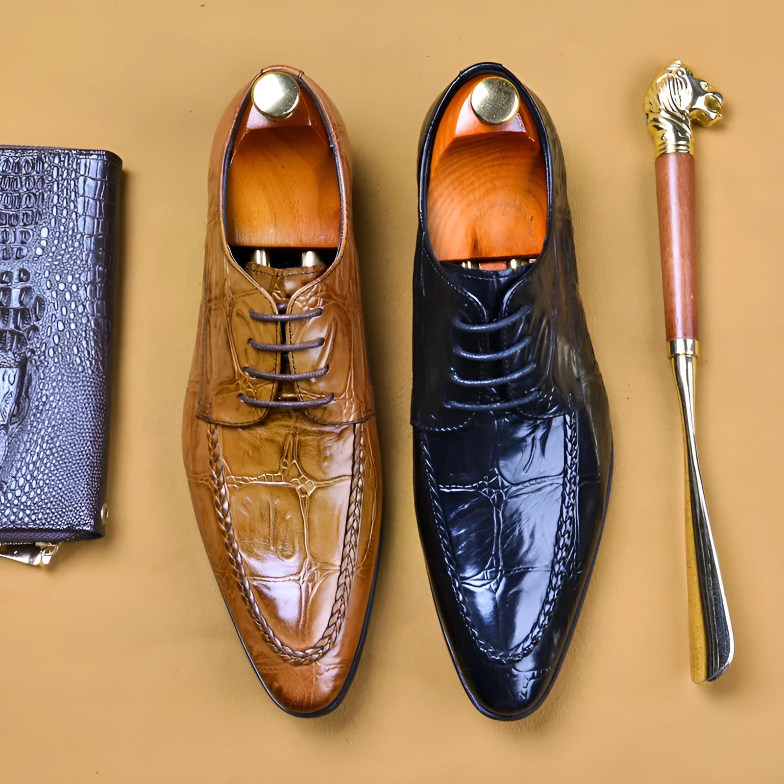 Black men's leather casual shoes with alligator pattern and metal horse bit buckle on a rubber sole.