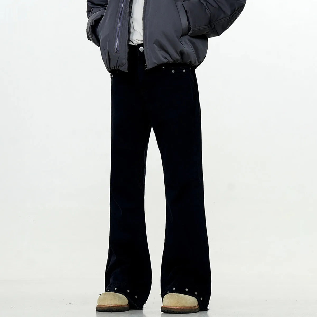 A pair of black straight-leg cotton jeans with a mid-waist fit and horn-style leg opening on a plain background.
