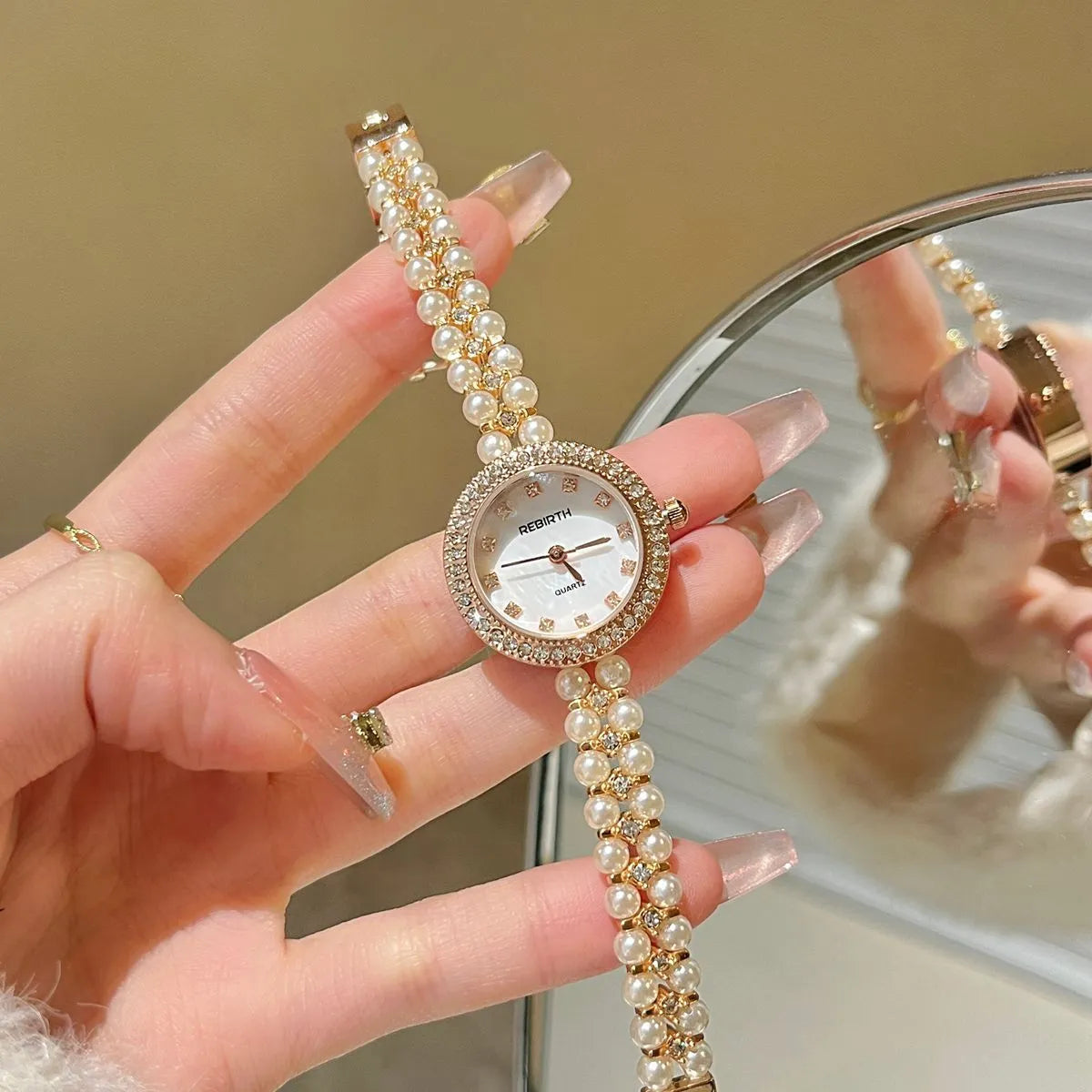Women's vintage freshwater pearl bracelet watch with 25mm dial, steel strap, and double row pearl design in silver