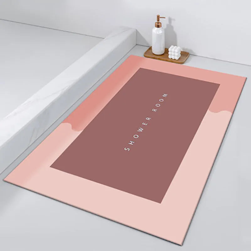 Oval diatomite bathroom floor mat in blue with natural rubber non-slip backing on tiled floor.