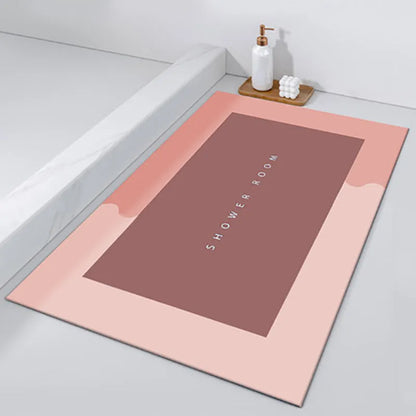 Oval diatomite bathroom floor mat in blue with natural rubber non-slip backing on tiled floor.