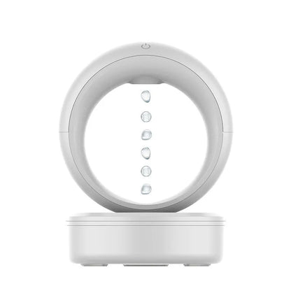 White round anti-gravity desk humidifier showing levitating water droplet effect with USB connection