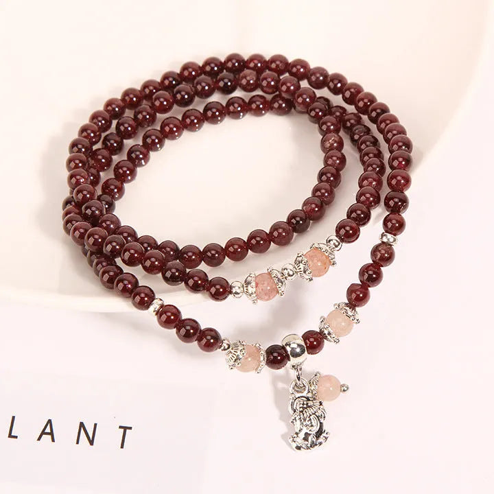 Women's crystal floral bracelet with wine red garnet stones and sauteed green beans detailing