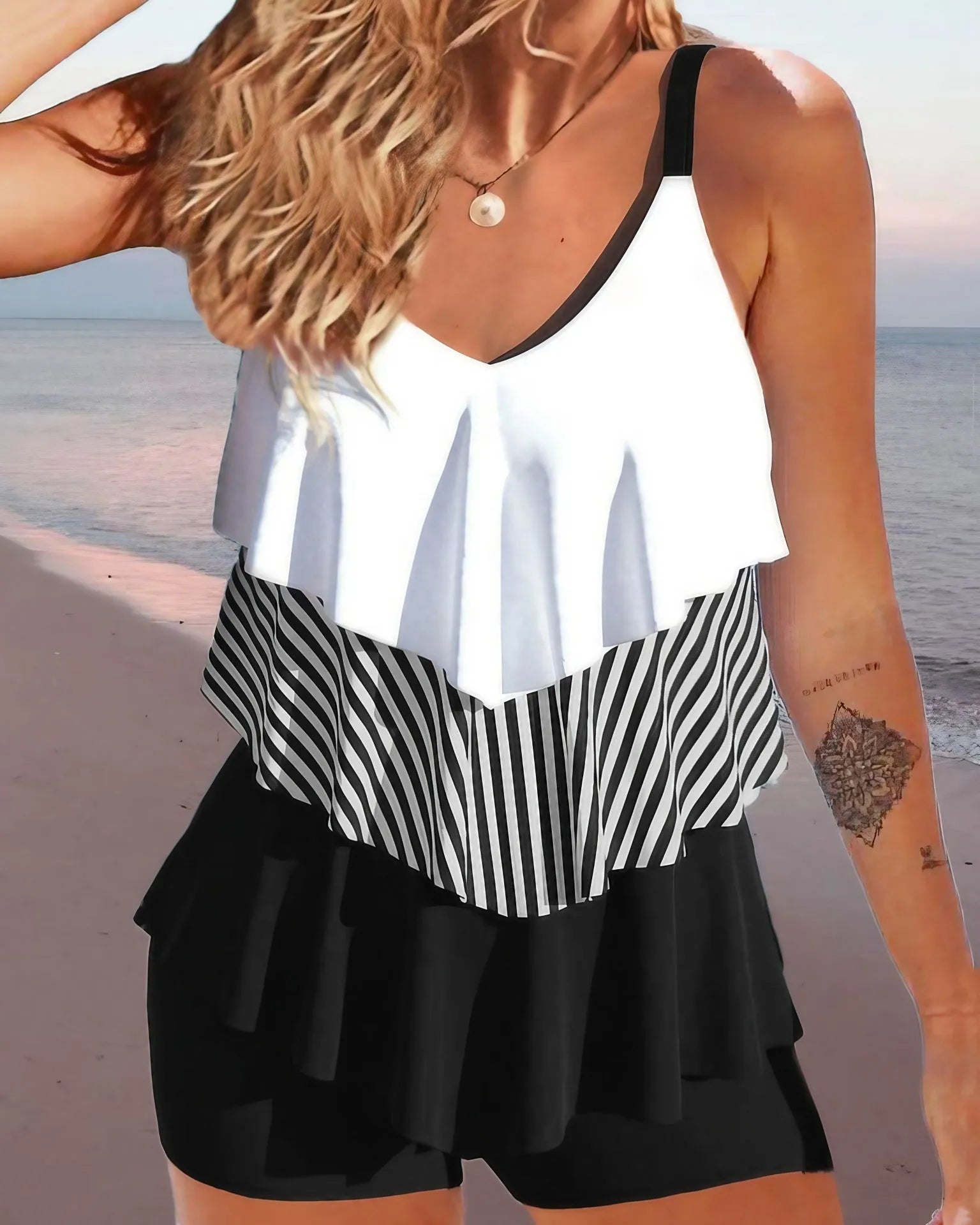 Women's backless sleeveless bikini swimsuit with ruffles and spaghetti straps in a floral pattern.