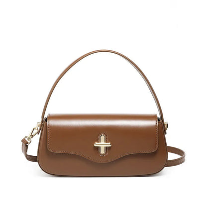 Genuine leather baguette handbag in horizontal square shape with clamshell opening and internal zip compartments