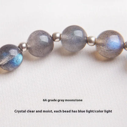 Close-up of a women's 925 silver bracelet with a 7.5mm grey moonlight strawberry stone and honeysuckle zodiac design.