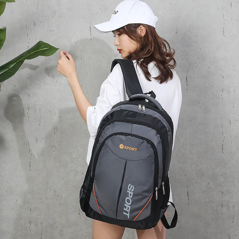 Large black nylon backpack with curved shoulder straps and letter detailing, shown from the side.