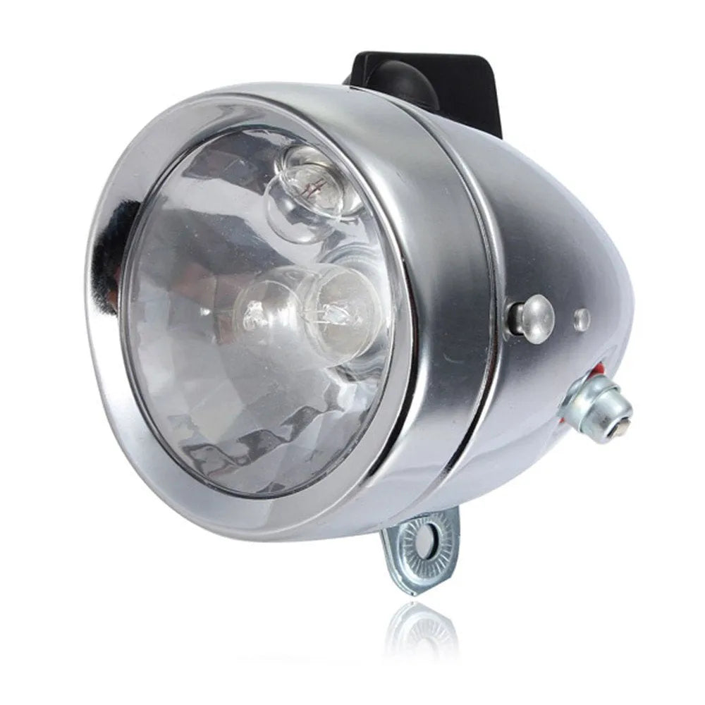 Silver dynamo-powered bicycle light set with generator unit for friction drive on wheel.
